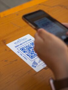Marketing team comparing QR code scan results from flyers menus and direct mail campaigns