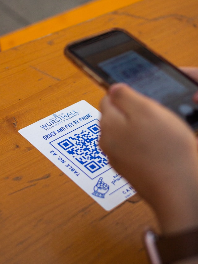 Marketing team comparing QR code scan results from flyers menus and direct mail campaigns